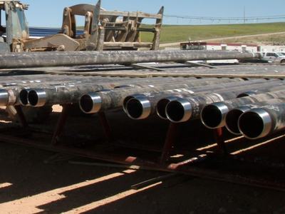 Joints of oilfield casing with threaded pin ends on pipe racks